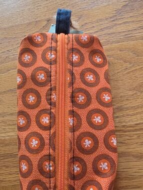 Nando's Malaria Awareness Orange Circular Print Zip Pouch